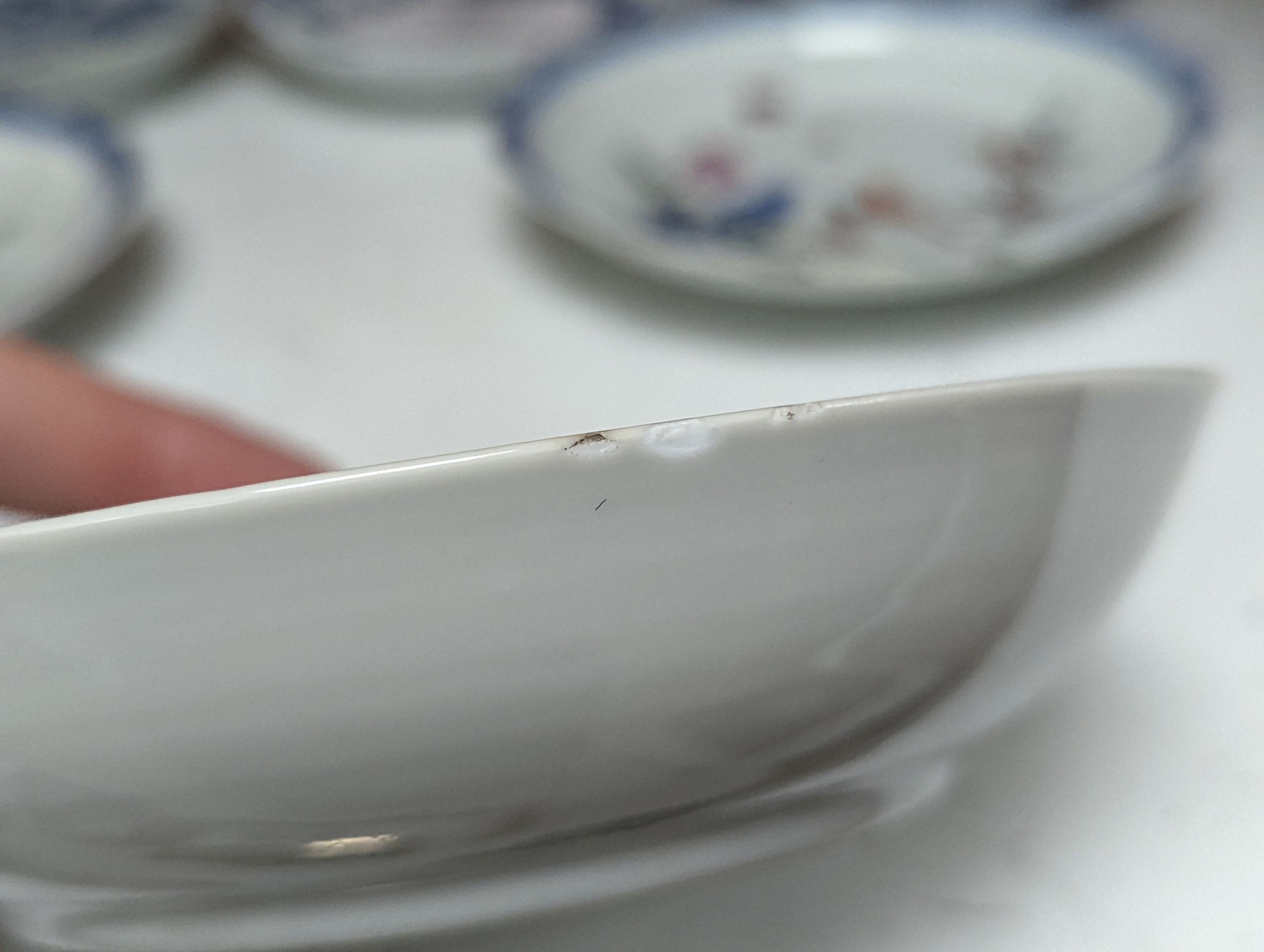 Seven 18th century Chinese saucer dishes, largest 14 cms diameter.